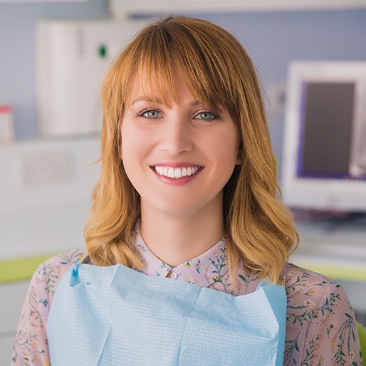 Woman in dental office sharing healthy smile